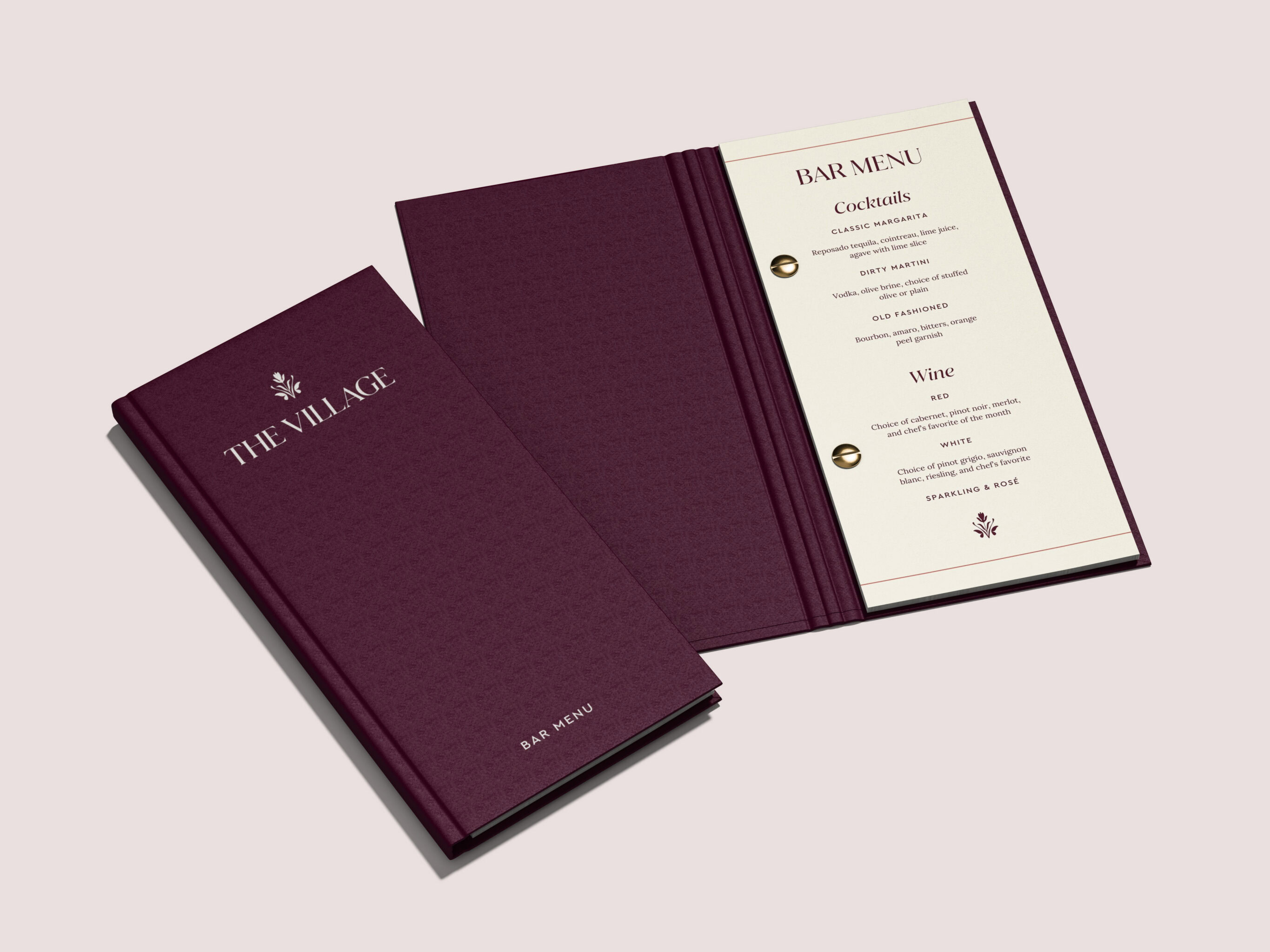 The Village bar menu with burgundy cover and cream interior pages listing cocktails and wines